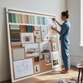 Designer adding final image to a large concept board with paint samples, fabric swatches, and furniture references